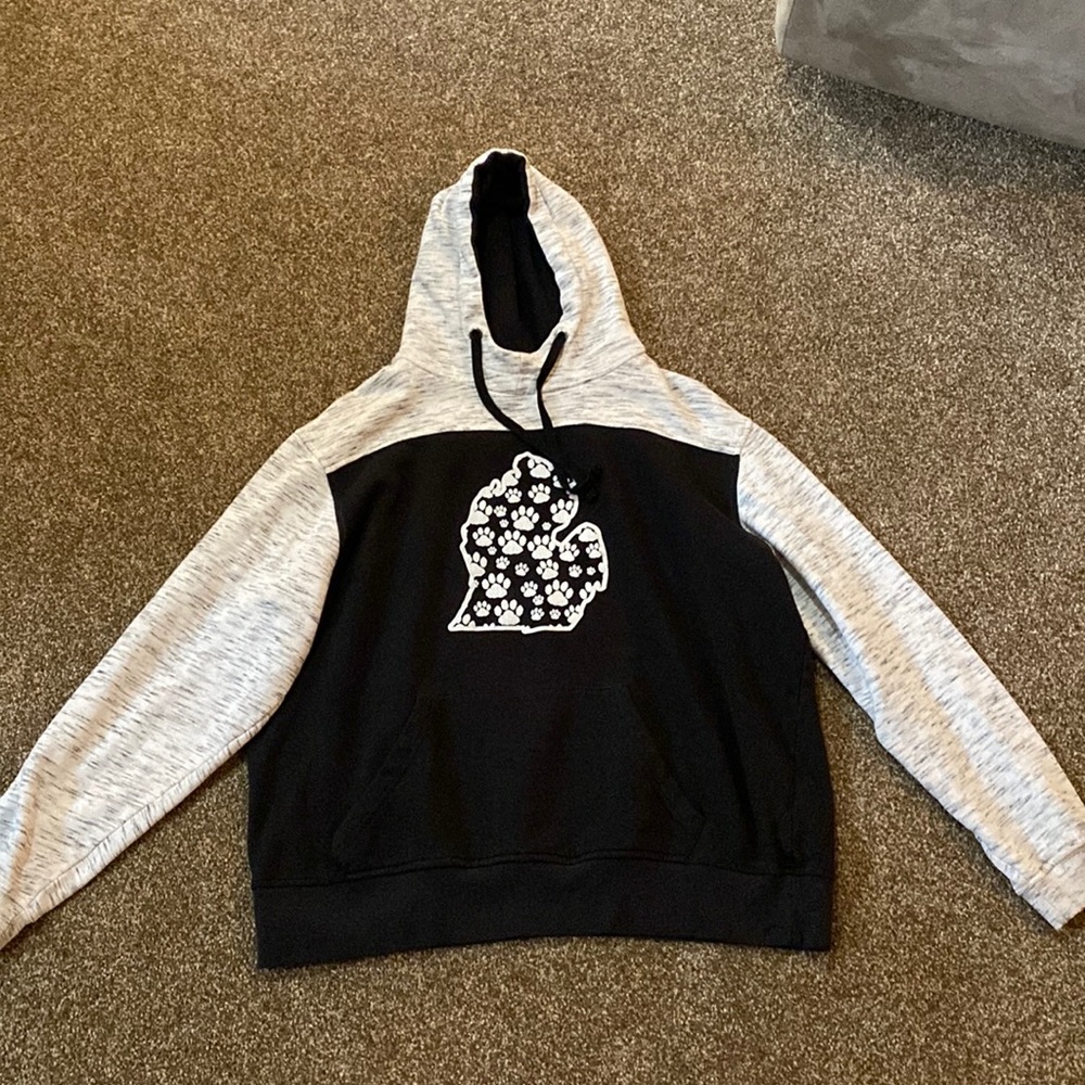 It is a sweatshirt, size Small, and it is black, grey, and white.